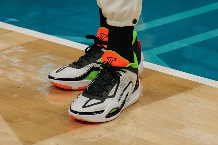 Boston Celtics forward Jayson Tatum's white and orange Jordan Brand shoes.